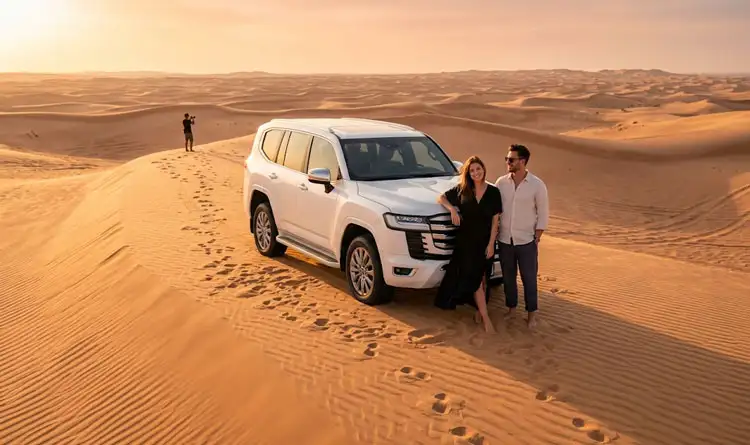 VIP private desert safari in Abu Dhabi with a clean 4x4 Land Cruiser on the dunes and a couple enjoying exclusive service.